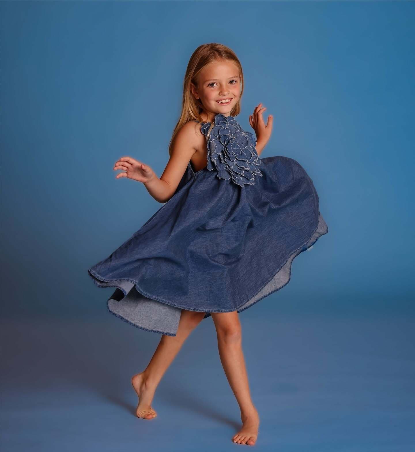 A young DanceSpace dancer mid-turn, smiling